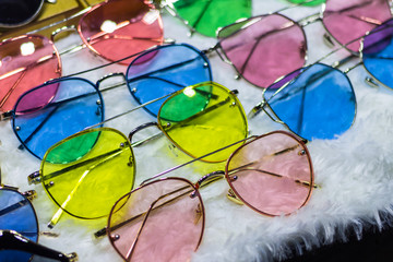 Sunglass shop selling different bright colored funky glasses for UV protection from the sun.  Eye...