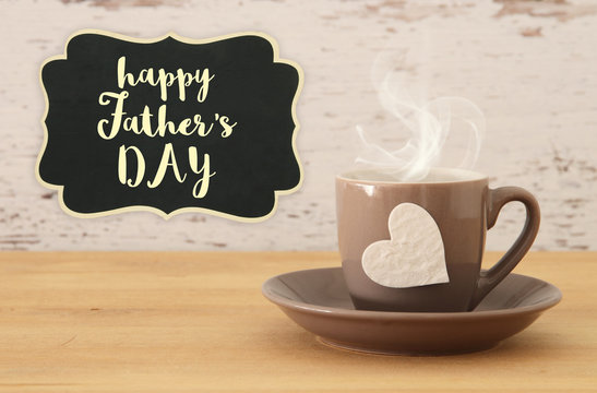 Image of hot coffee or tea over wooden table. Father's day concept.