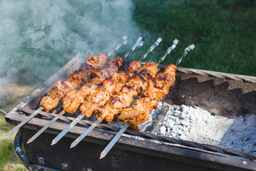Appetizing hot shish kebab on metal skewers