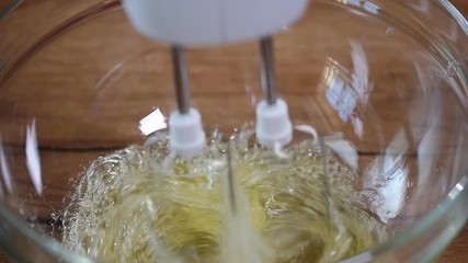 Beating egg white with electric whisk.