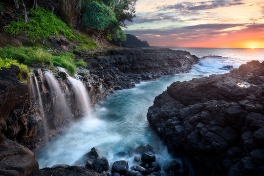 Waterfall at Queen's Bath during sunset, Kauai, Hawaii