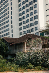 old house in front of a skyscraper