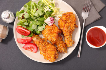 fried chicken leg and salad