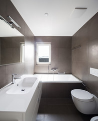 Bathroom in modern apartment with white walls, nobody in the scene
