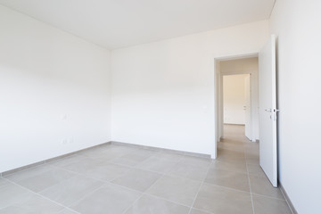 Empty room in a modern apartment with white walls, nobody in the scene