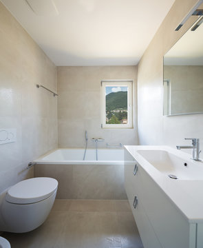 Bathroom in modern apartment with white walls, nobody in the scene