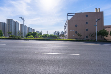 Fototapeta na wymiar empty asphalt road with modern office building