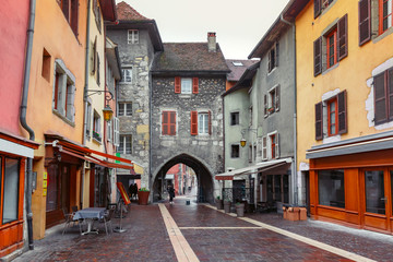 Fototapeta na wymiar Gorgeous medieval arch gate Sepulchre Gate on Rue Sainte-Claire in Old Town of Annecy, France