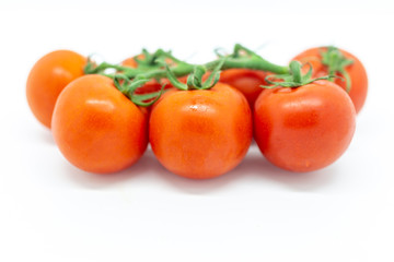 Red tomatoes against a white background