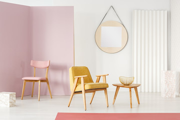 Fototapeta na wymiar Pink chair and yellow armchair