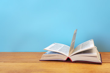 Open book on woden background