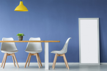 Chairs, table against blue wall