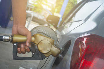 Filling gasoline into a car.