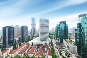 Fototapeta premium Aerial view of Shanghai's high density central business area. High rise office buildings and skyscrapers with glass surface. Urban roads with multiple lanes and green city park. Shanghai, China