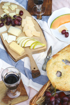 Summer picnic with cheese, wine, fruits and bread. Picnic at the park.