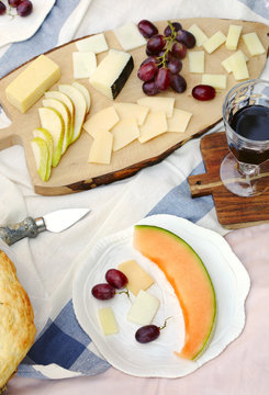 Summer picnic with cheese, wine, fruits and bread. Picnic at the park.