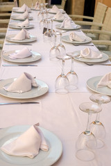 Festive empty table with plates and glasses