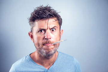 Sick man with thermometer in mouth,looking and worry at thermometer on white background,healthcare...