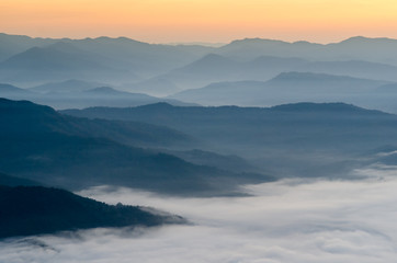 Fototapeta premium Sunset over mountains and fog