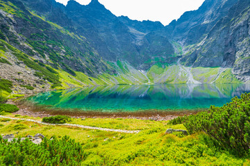 a mountain lake Czarny Staw with clear water in the Tatra mountains, a landmark of Poland