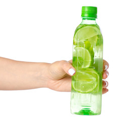 The bottle of water with lime in hand on white background isolation