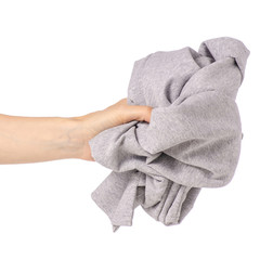 Crumpled gray cloth dress in hand on white background isolation