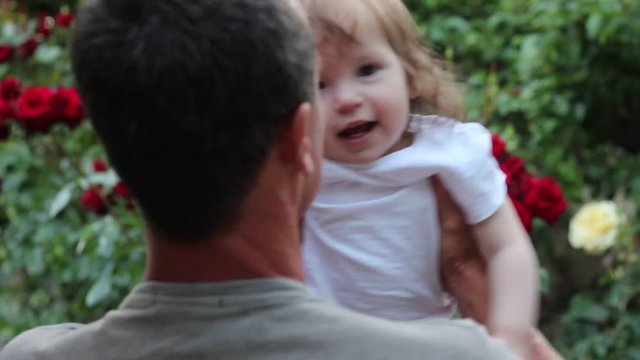 Happy father and one year old baby girl. Smiling little girl