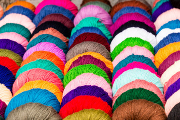 A selection of coloured yarn for sale at a shop in India.