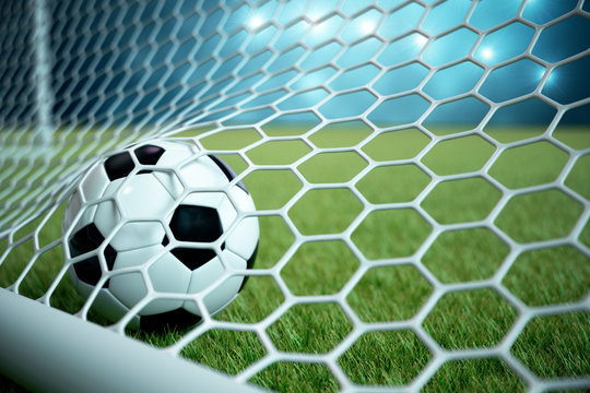 3d rendering soccer ball in goal. Soccer ball in net with spotlight and stadium light background, Success concept. Soccer ball on blue background with grass.