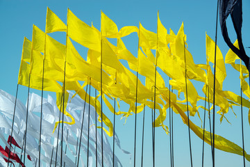 yellow flags and blue sky. triangular flags in the wind against the blue sky. Colors of Ukraine