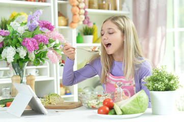 Cute girl preparing fresh salad