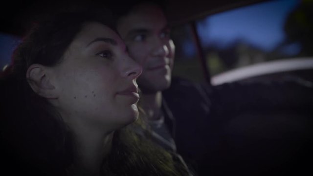Closeup Of Cute Couple Talking In Back Seat Of Moving Car At Night In Downtown Los Angeles, CA (Slow Motion)