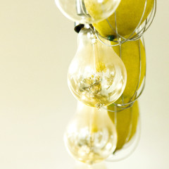 there are many Lamps hang in a row like a chandelier in a shuffle with lemons macro