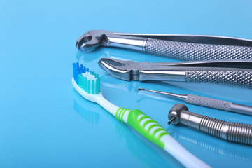dental care toothbrush with dentist tools on mirror background