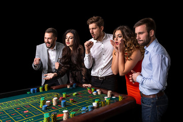 Group of young people looking excited at spinning roulette