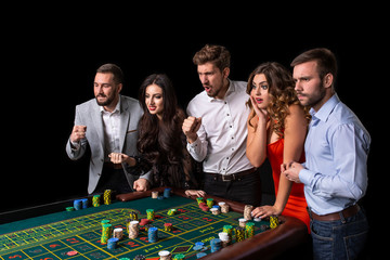 Group of young people looking excited at spinning roulette