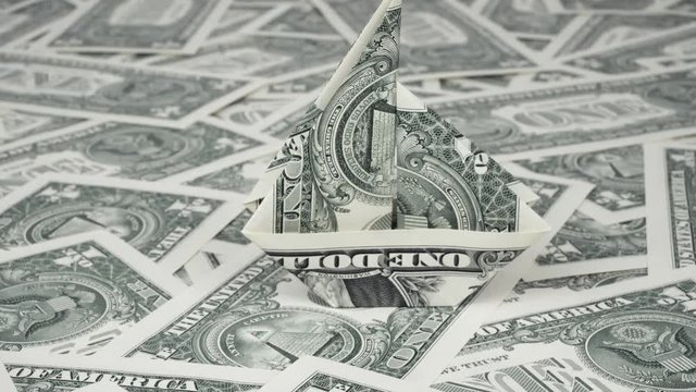 Investment concept. Ship origami mafe of dollars