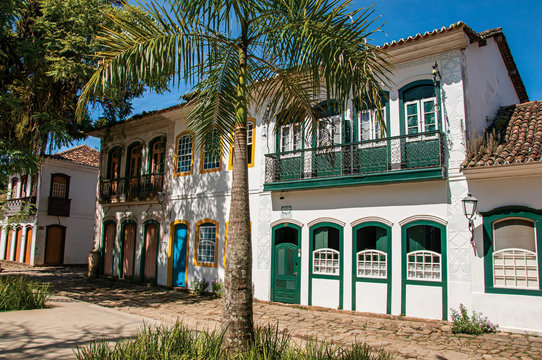 Old colored houses, palm tree and cobblestone in Paraty, an amazing and historic town totally preserved in the coast of the Rio de Janeiro State, southwestern Brazil
