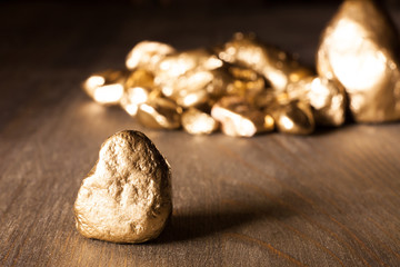 golden nuggets on wooden surface