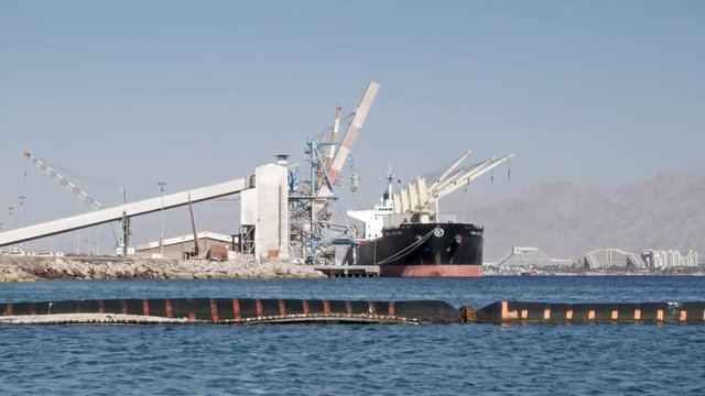 Cargo ship in the Eilat port, in the background can be seen the city of Eilat