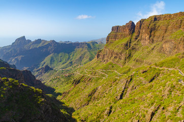 Fototapeta na wymiar Winding road leading to a small village between the mountains, Tenerife, Canary Islands, Spain