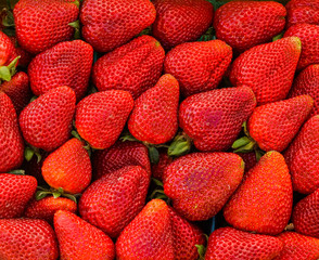 freshly picked bright red strawberries in a farmers market