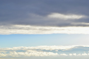 A strip of sky and cumulonimbus clouds.