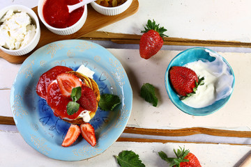 Cottage cheese pancakes with sour cream and strawberry jam, on a white wooden background, healthy breakfast. copy space, set