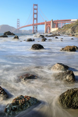 View of the Golden Gate Bridge from Rugged Marshall Beach in High Tide. The Presidio, San Francisco, California, USA.