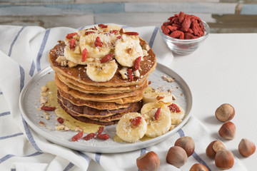 Pancakes with banana, walnuts, goji and honey