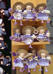 Traditional, purple and happily smiling lavender puppets with colorful costumes in Pula, Croatia