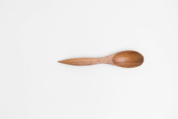 Single wodden spoon on a white background in a studio