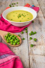 Fresh green pea soup with pea seeds.