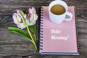 Notebook,Pink Tulip and Cup of Coffee .Spring Morning Concept with Hello Monday Message
